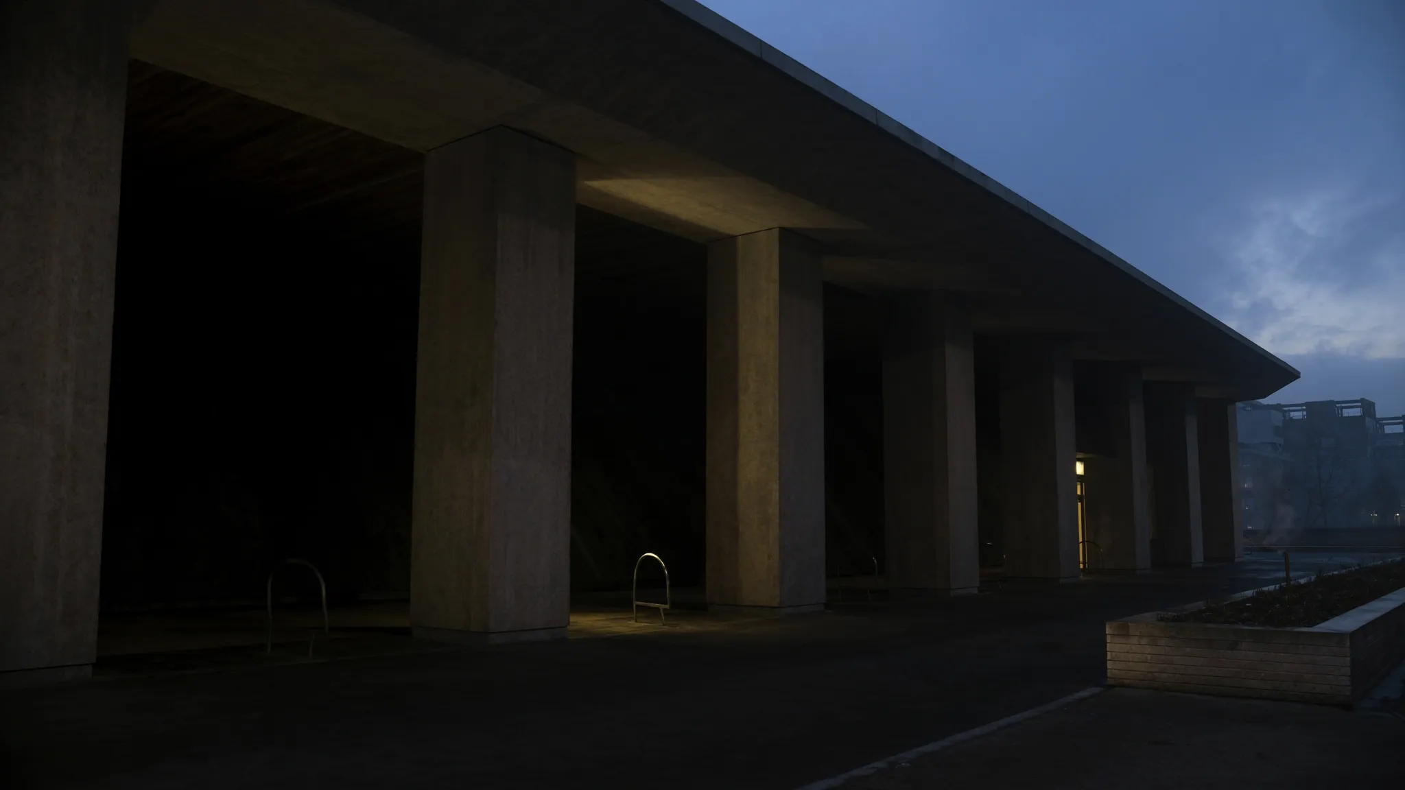 A monumental stone colonnade at blue hour